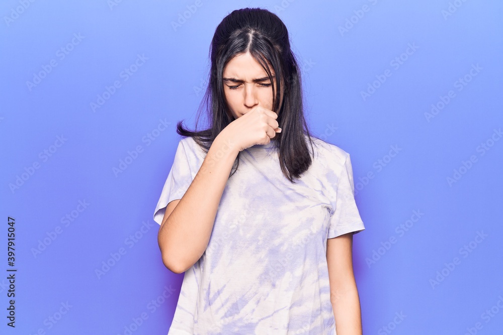 Young beautiful girl wearing casual t shirt feeling unwell and coughing as symptom for cold or bronchitis. health care concept. Young beautiful girl wearing casual t shirt feeling unwell and coughing as symptom for cold or bronchitis. health care concept.