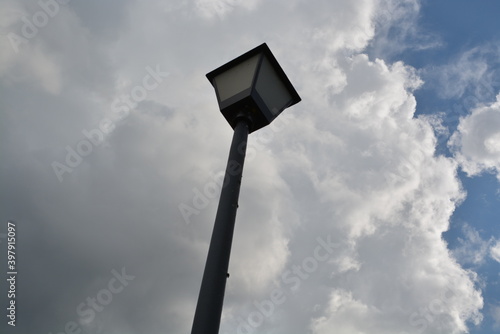 street lamp against blue sky with clouds