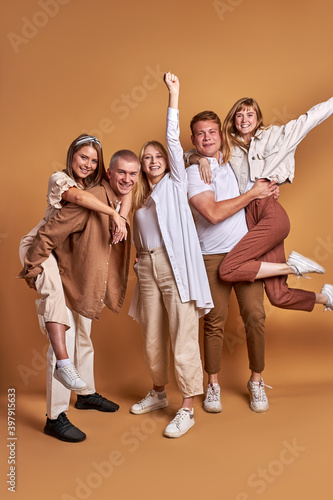 fancy friendly youth isolated in studio  portrait. group of young people hug each other  smile  feel happiness