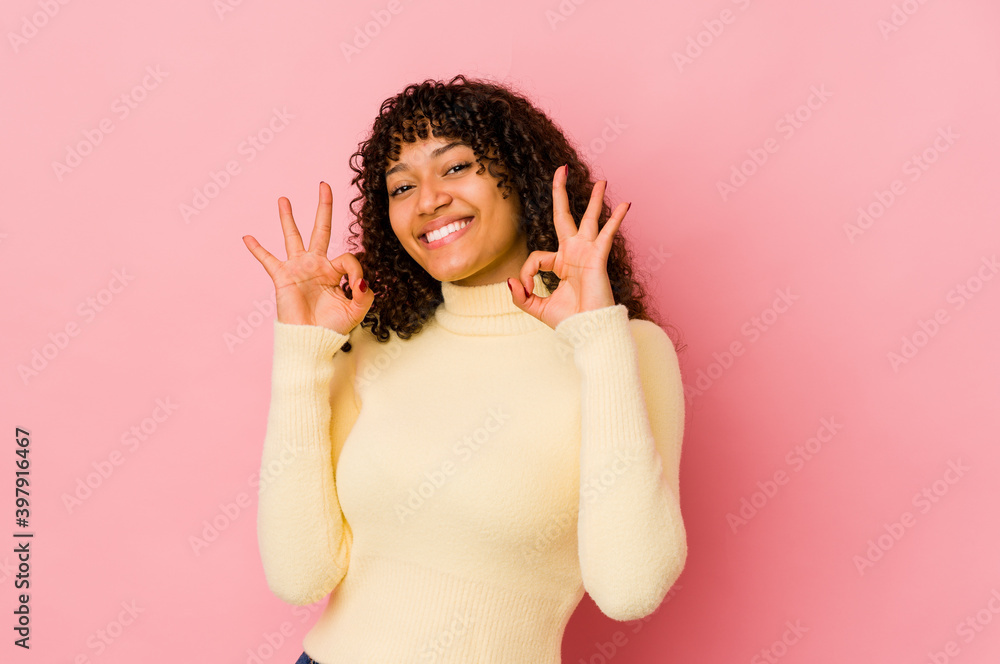 Young african american afro woman isolated cheerful and confident showing ok gesture. Young african american afro woman isolated cheerful and confident showing ok gesture.