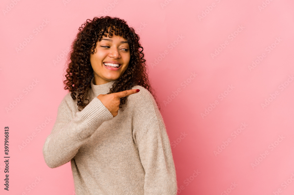 Young african american afro woman isolated looks aside smiling, cheerful and pleasant. Young african american afro woman isolated looks aside smiling, cheerful and pleasant.