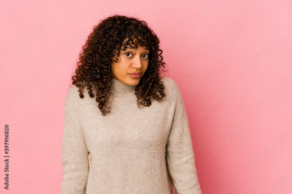 Young african american afro woman isolated shrugs shoulders and open eyes confused. Young african american afro woman isolated shrugs shoulders and open eyes confused.