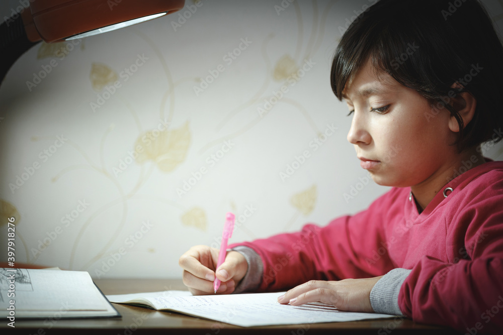 Pretty girl writes with a pen in a notebook Pretty girl writes with a pen in a notebook