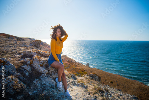 Photo shoot of an attractive model on the sea coast.