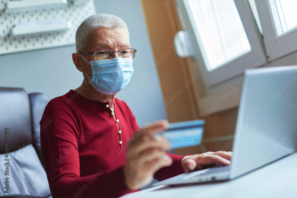 Elderly woman checking her bank account Elderly woman checking her bank account