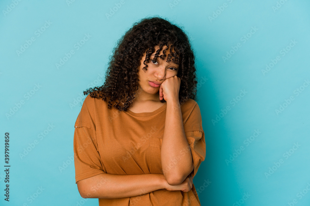Young african american afro woman isolated who feels sad and pensive, looking at copy space. Young african american afro woman isolated who feels sad and pensive, looking at copy space.