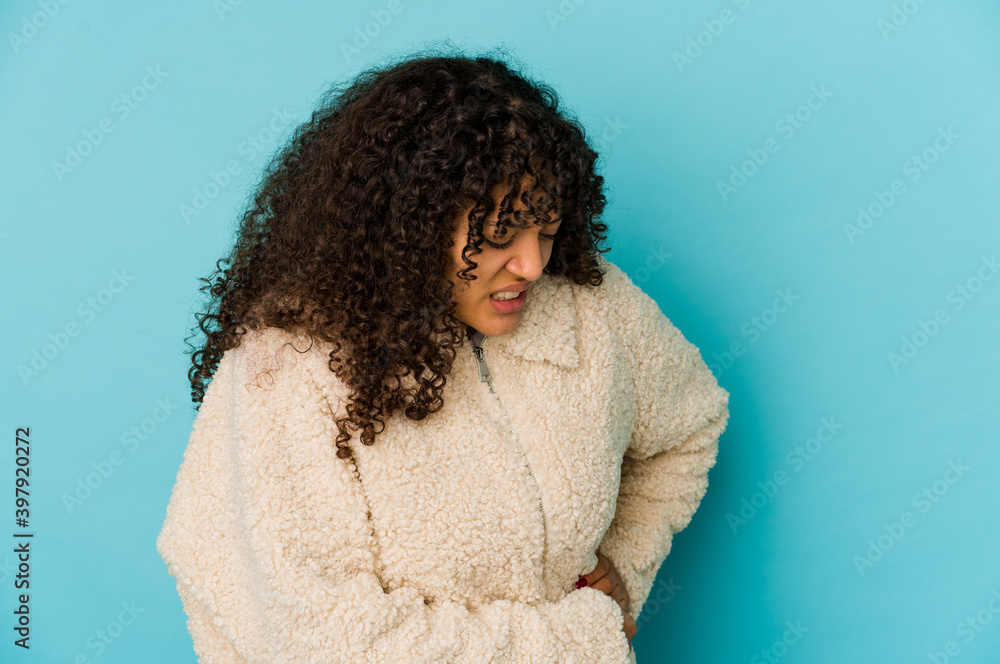 Young african american afro woman isolated having a liver pain, stomach ache. Young african american afro woman isolated having a liver pain, stomach ache.