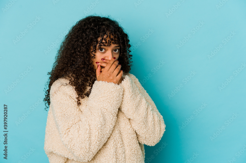 Young african american afro woman isolated covering mouth with hands looking worried. Young african american afro woman isolated covering mouth with hands looking worried.