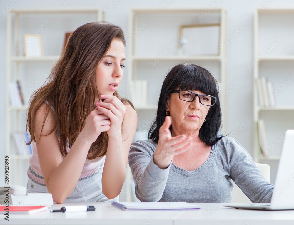 Daughter explaining to mom how to use computer Daughter explaining to mom how to use computer