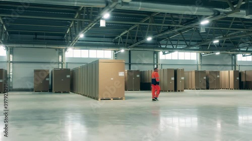 Worker is walking along the storage of the refrigeration factory. Factory facility intside. photo
