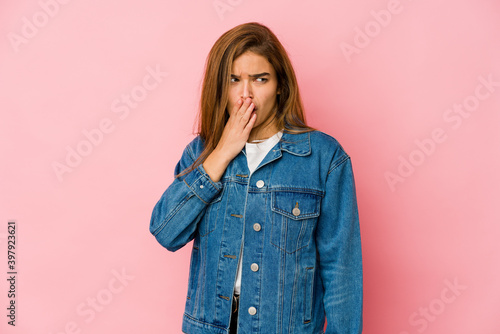 Young skinny caucasian teenager girl yawning showing a tired gesture covering mouth with hand.