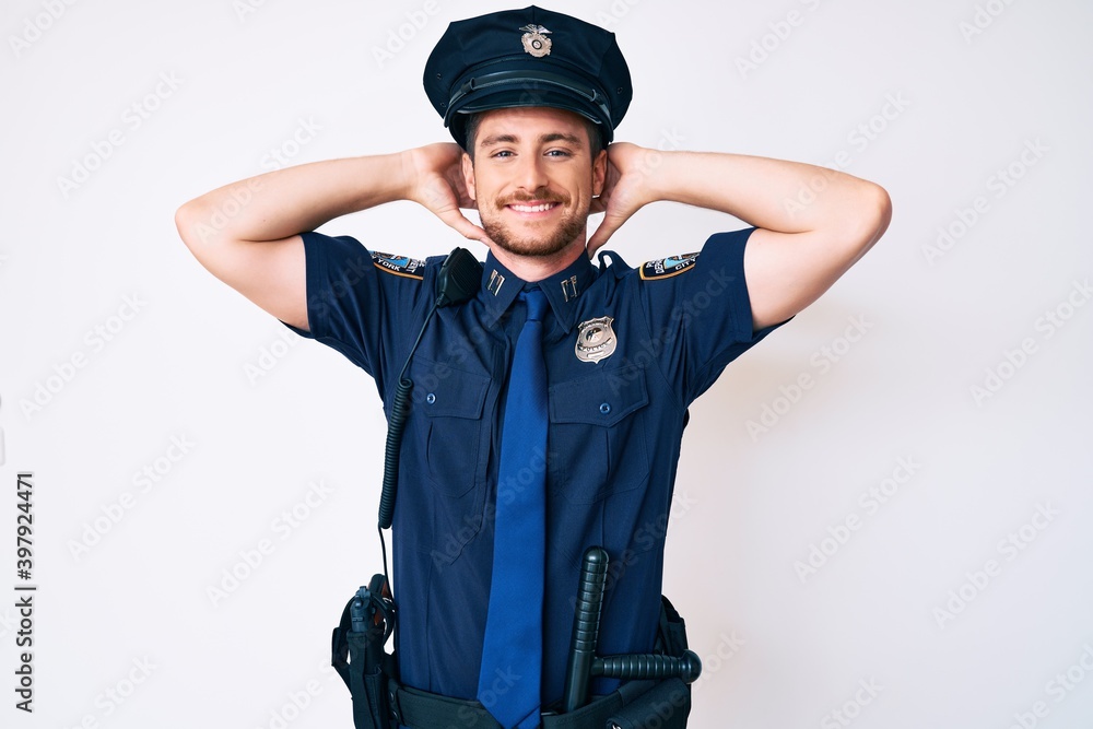 Young caucasian man wearing police uniform relaxing and stretching, arms and hands behind head and neck smiling happy Young caucasian man wearing police uniform relaxing and stretching, arms and hands behind head and neck smiling happy
