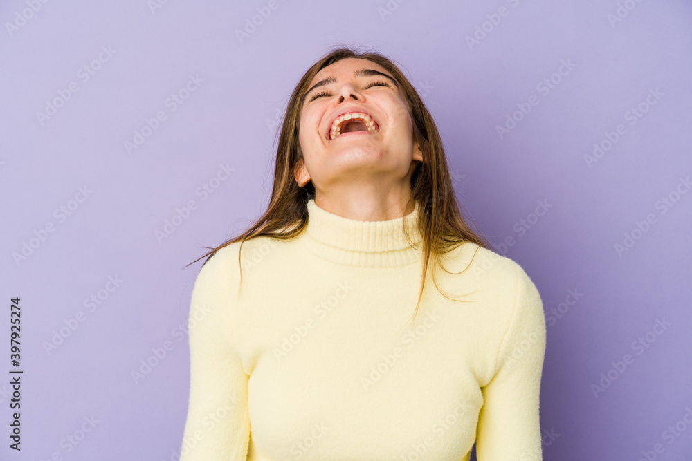 © Asier - Young skinny caucasian girl teenager on purple background relaxed and happy laughing, neck stretched showing teeth. © Asier - Young skinny caucasian girl teenager on purple background relaxed and happy laughing, neck stretched showing teeth.