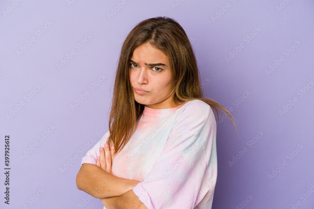 Young skinny caucasian girl teenager on purple background tired of a repetitive task. Young skinny caucasian girl teenager on purple background tired of a repetitive task.