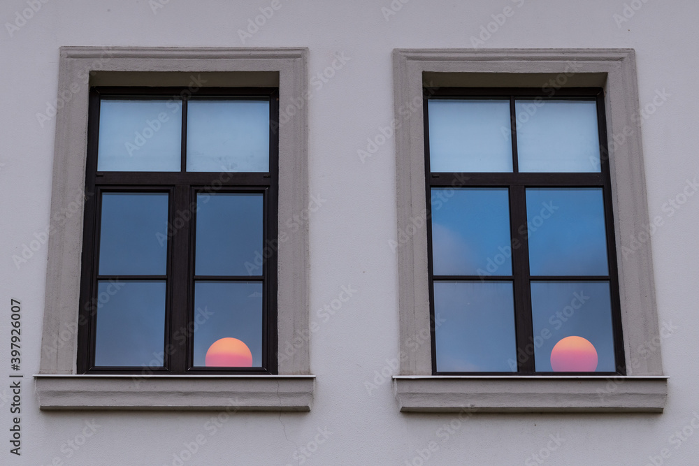 Two windows with red light balls behind them