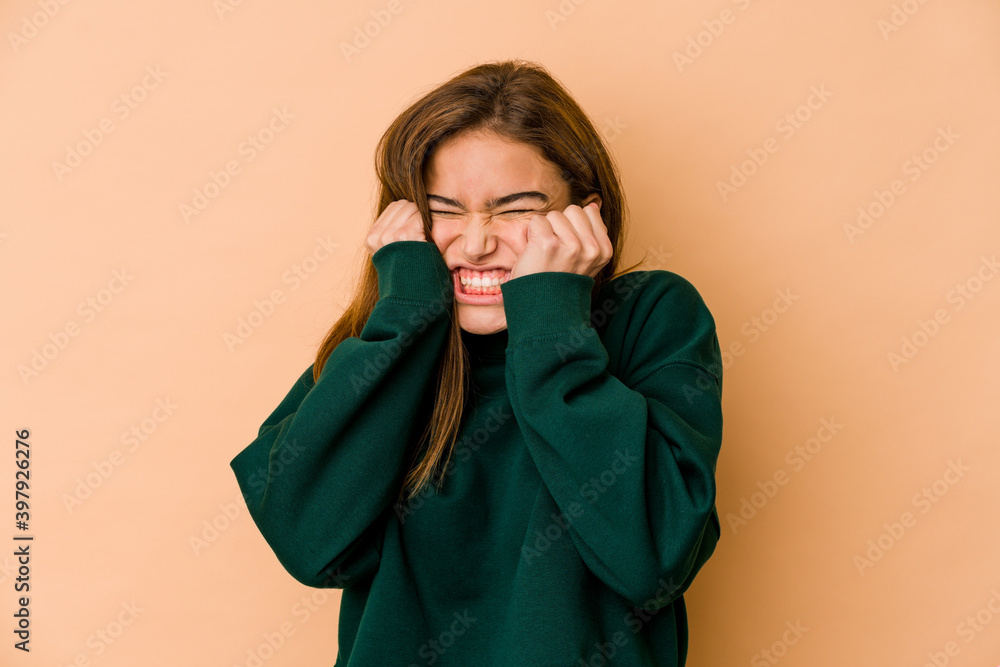Young skinny caucasian teenager girl covering ears with hands.