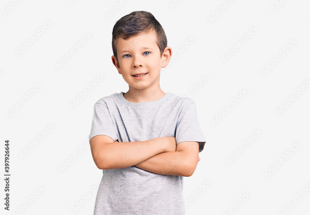 Cute blond kid wearing casual clothes happy face smiling with crossed arms looking at the camera. positive person. Cute blond kid wearing casual clothes happy face smiling with crossed arms looking at the camera. positive person.