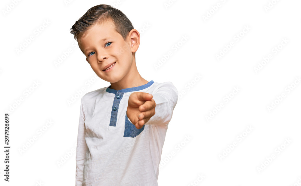 Adorable caucasian kid wearing casual clothes smiling friendly offering handshake as greeting and welcoming. successful business. Adorable caucasian kid wearing casual clothes smiling friendly offering handshake as greeting and welcoming. successful business.