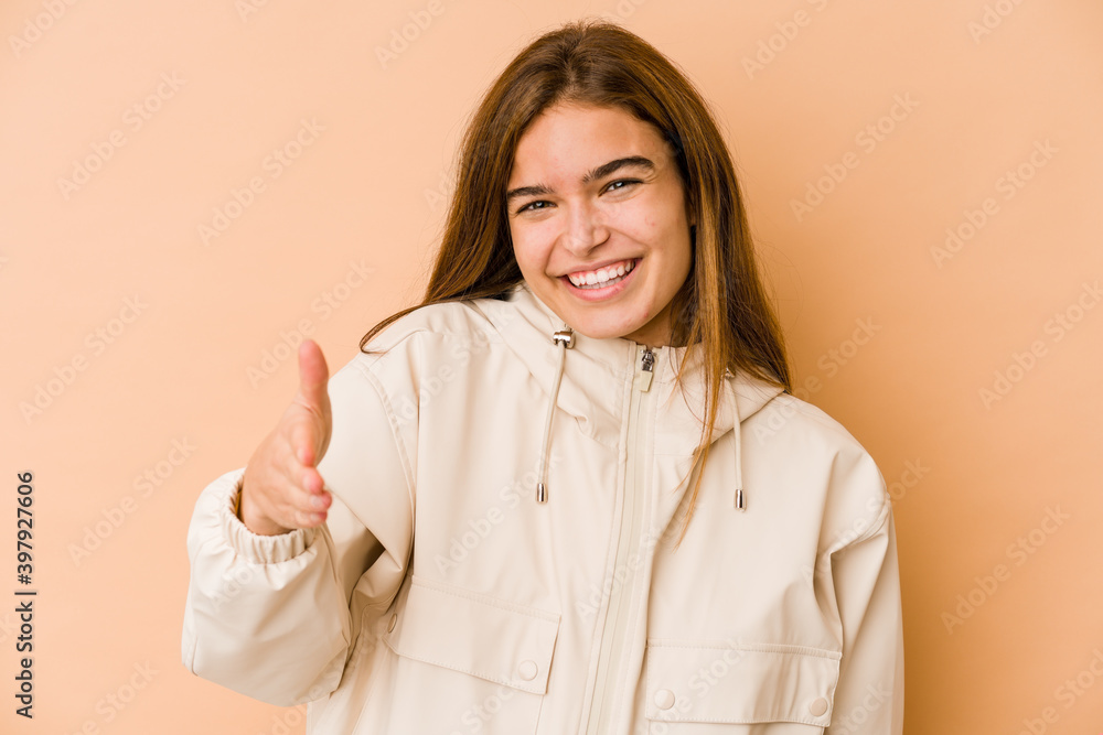 Young skinny caucasian teenager girl stretching hand at camera in greeting gesture. Young skinny caucasian teenager girl stretching hand at camera in greeting gesture.