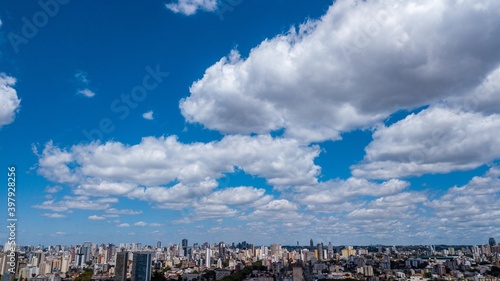 Panoramic drone view of the Alto de XV neighborhood, in the upper third the blue sky with clouds, below and in the background the center of Curitiba, capital of the state of Paraná, located in the sou