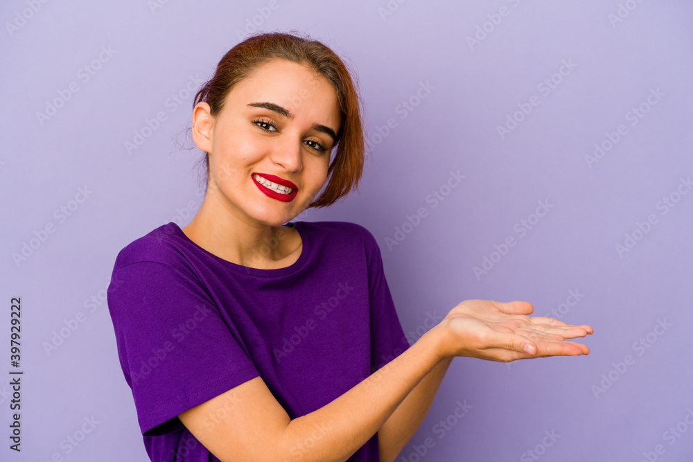 Young arab mixed race woman holding a copy space on a palm. Young arab mixed race woman holding a copy space on a palm.