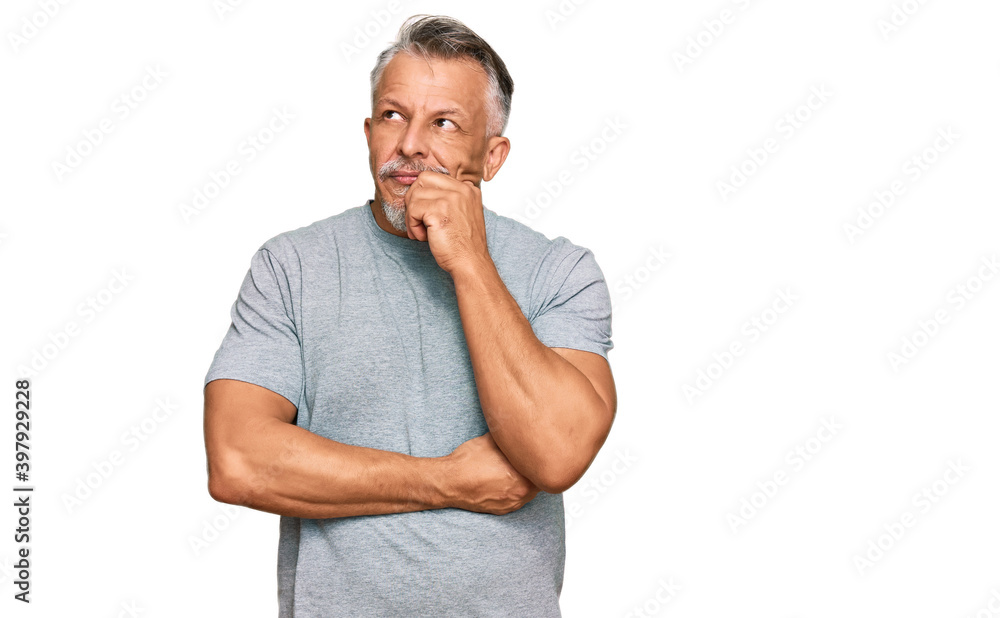 Middle age grey-haired man wearing casual clothes serious face thinking about question with hand on chin, thoughtful about confusing idea Middle age grey-haired man wearing casual clothes serious face thinking about question with hand on chin, thoughtful about confusing idea