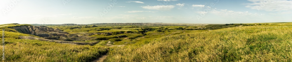 Panorama shot of wrinkled landscape in Badlands national park after sunrise in america