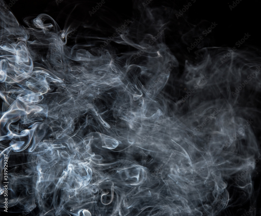 Fototapeta premium Abstract puffs of smoke on a black background.