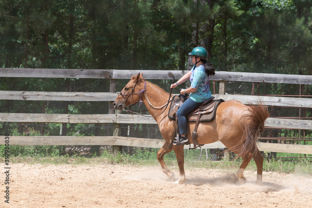 Teenage girl on horseback in a Texas corral Teenage girl on horseback in a Texas corral