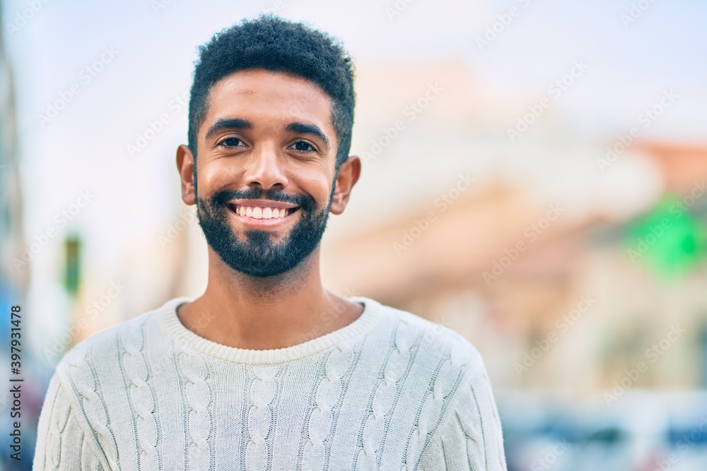 Young african american man smiling happy standing at the city. Young african american man smiling happy standing at the city.