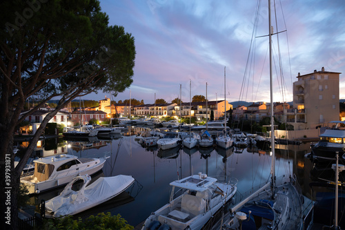 View on houses, roofs, canals and boats in Port Grimaud, Var, Provence, France during sunset