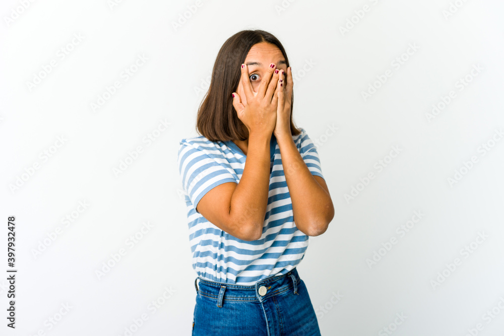 Young mixed race woman blink through fingers frightened and nervous. Young mixed race woman blink through fingers frightened and nervous.