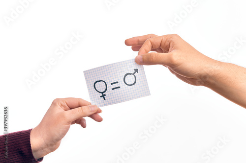 Cardboard banner with female and male symbol, women and men are equal message over isolated white background
