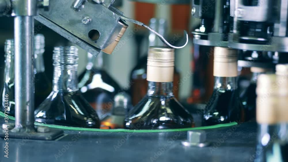 Factory conveyor is sealing bottles with alcohol Factory conveyor is sealing bottles with alcohol
