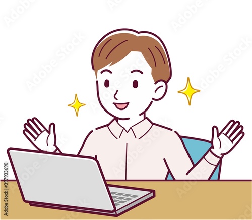 A man in a pink shirt using a computer