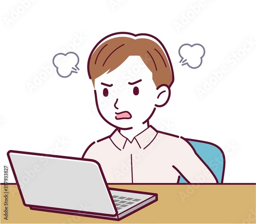 A man in a pink shirt using a computer