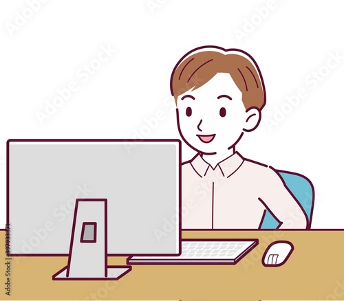 A man in a pink shirt using a computer