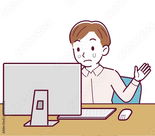 A man in a pink shirt using a computer
