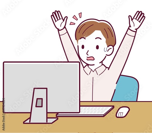 A man in a pink shirt using a computer