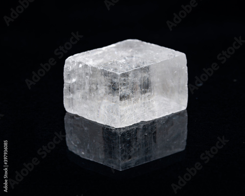 Optical Calcite from China isolated on a black mirror background. Alternative stone name: Iceland Spar.