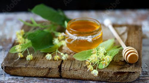 Fototapeta Naklejka Na Ścianę i Meble -  Linden flowers and a jar of linden honey.