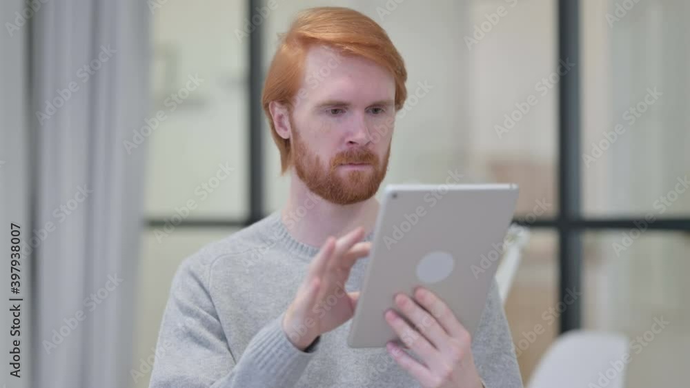 Portrait of Young Redhead Man using Digital Tablet Portrait of Young Redhead Man using Digital Tablet