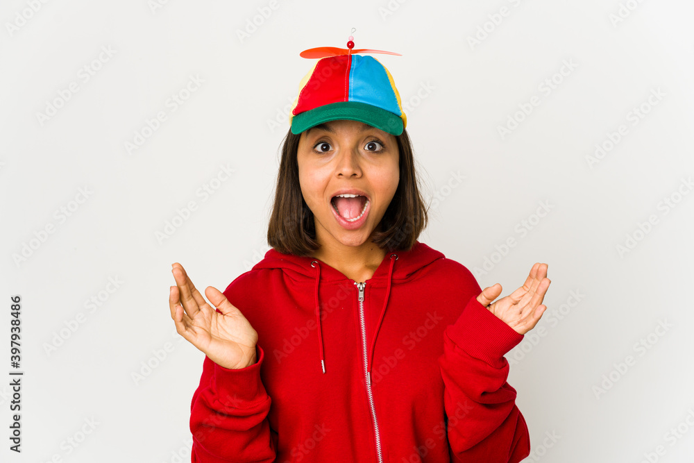 Young hispanic woman wearing a cap with propeller isolated surprised and shocked. Young hispanic woman wearing a cap with propeller isolated surprised and shocked.