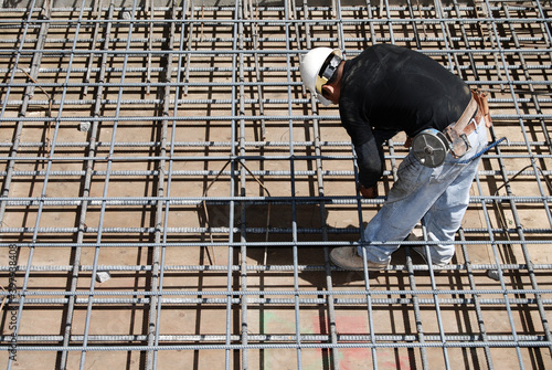 Concrete mason tying rebar for a new concrete deck