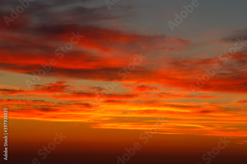 sunset with the reddish sun near the sea © Imaxepress