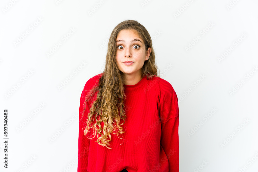 Young caucasian woman shrugs shoulders and open eyes confused. Young caucasian woman shrugs shoulders and open eyes confused.