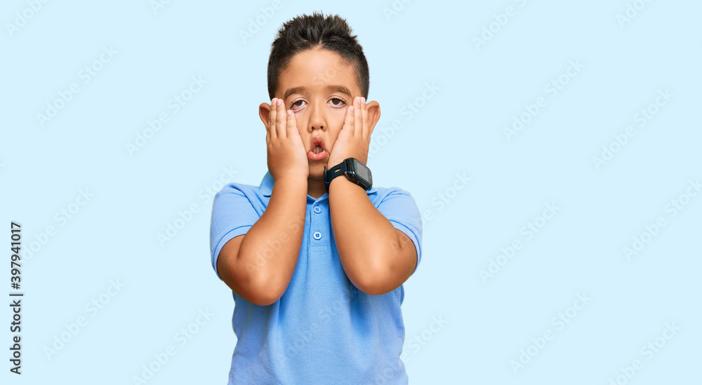 Little boy hispanic kid wearing casual clothes tired hands covering face, depression and sadness, upset and irritated for problem Little boy hispanic kid wearing casual clothes tired hands covering face, depression and sadness, upset and irritated for problem