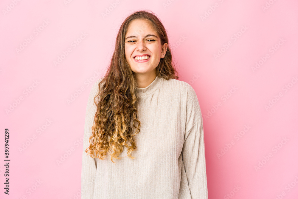 Young caucasian woman laughs and closes eyes, feels relaxed and happy. Young caucasian woman laughs and closes eyes, feels relaxed and happy.