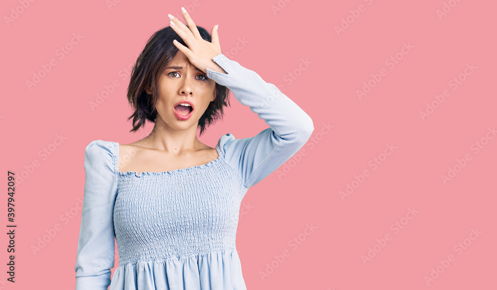 Young beautiful girl wearing casual clothes surprised with hand on head for mistake, remember error. forgot, bad memory concept. Young beautiful girl wearing casual clothes surprised with hand on head for mistake, remember error. forgot, bad memory concept.
