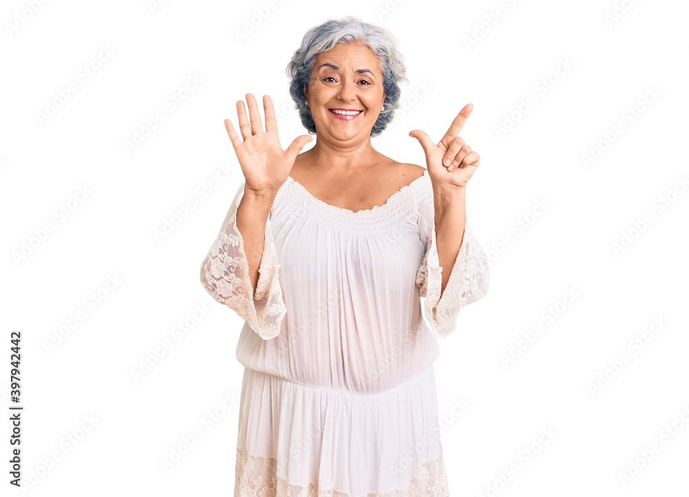 Senior woman with gray hair wearing bohemian style showing and pointing up with fingers number seven while smiling confident and happy. Senior woman with gray hair wearing bohemian style showing and pointing up with fingers number seven while smiling confident and happy.